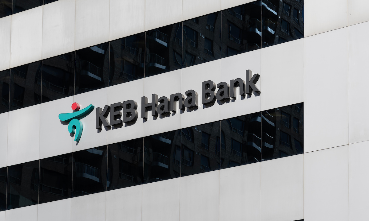 Illustration of a bank building with cryptocurrency symbols emerging from it.