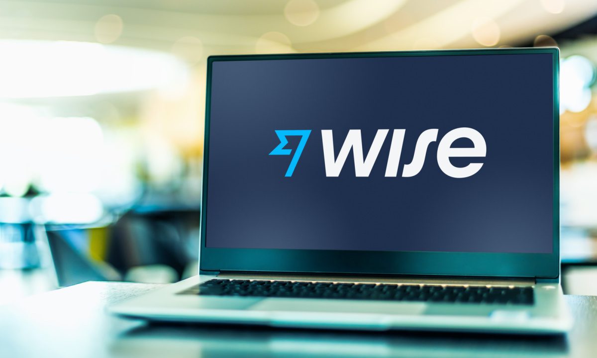 Wise app on phone showing cross-border transfer with surging transaction graph