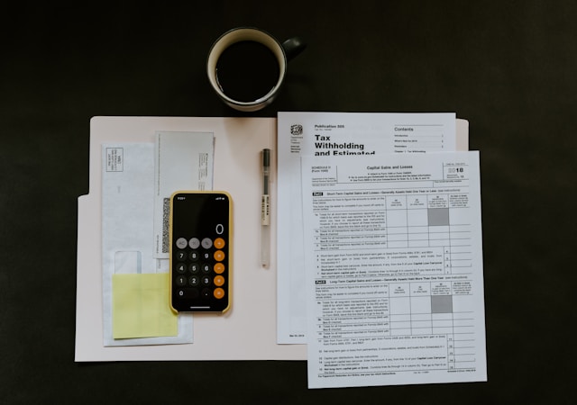 A graphic illustration of a small business owner looking relieved while using a tablet displaying a tax form, with a bank logo subtly incorporated.