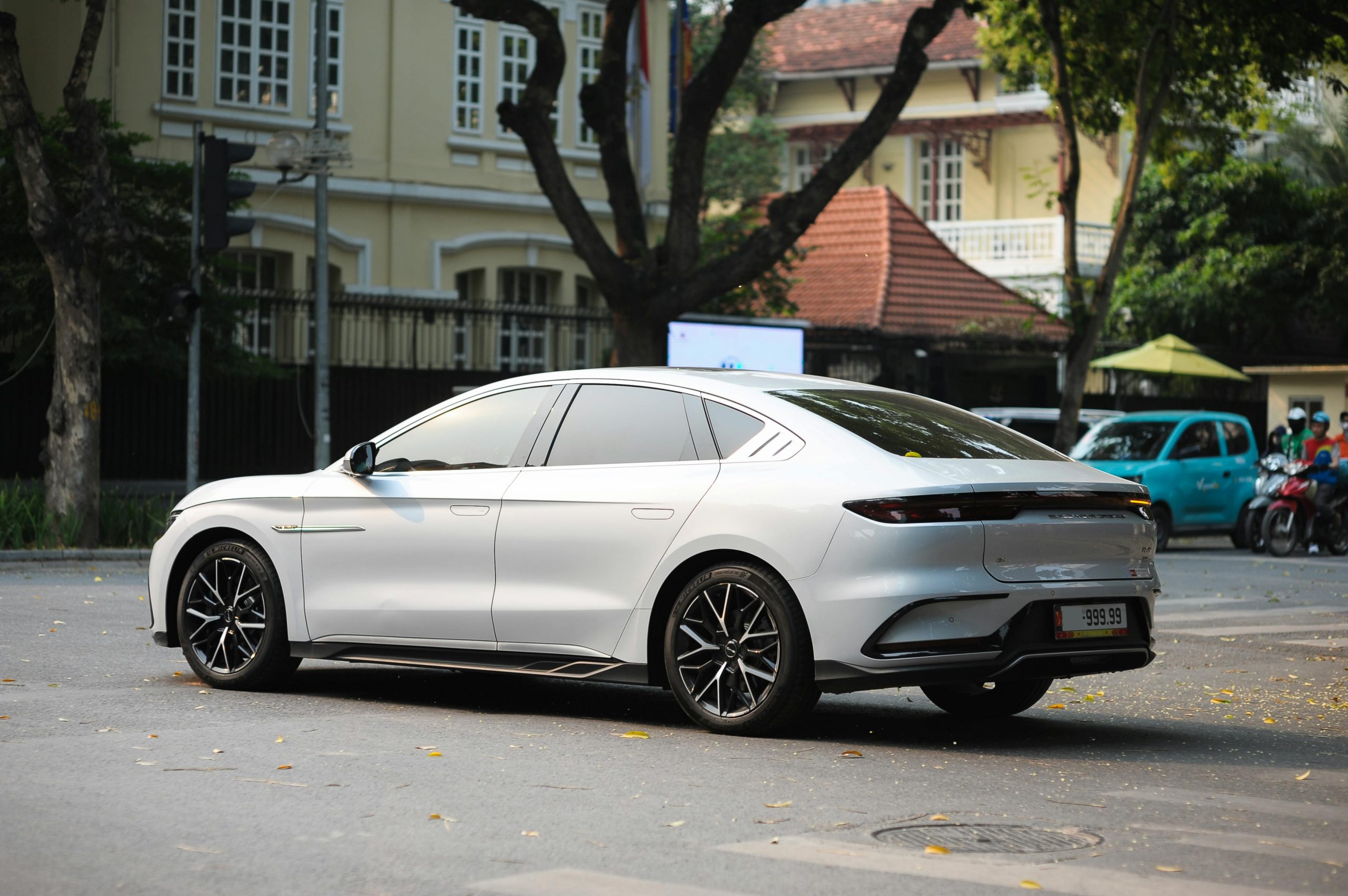 A BYD electric vehicle parked in a modern urban setting with a bolttech logo subtly integrated into the background.