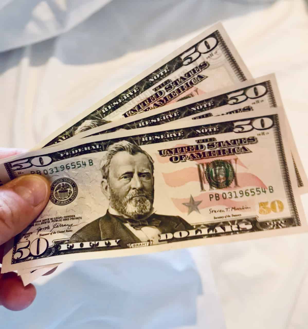 A diverse group of people in a bustling market scene, some using smartphones to make payments.