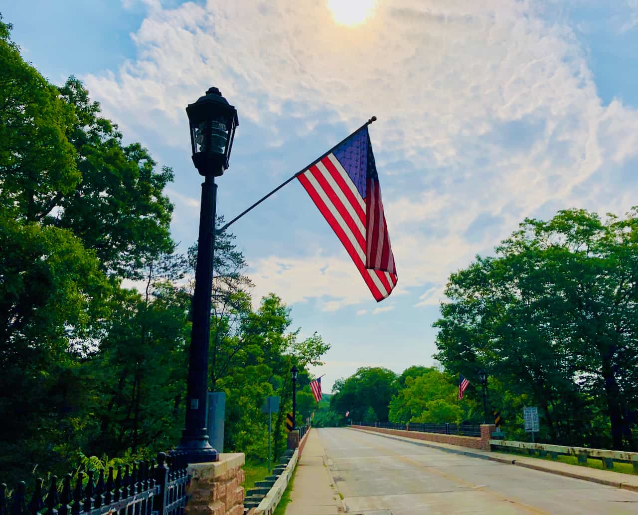 Two abstract geometric shapes, one representing Thredd and the other Cross River, merging to form a bridge over a stylized map of the United States.