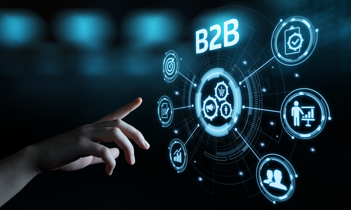 Solo founder coding AI for B2B procurement at a minimalist desk with glowing screens