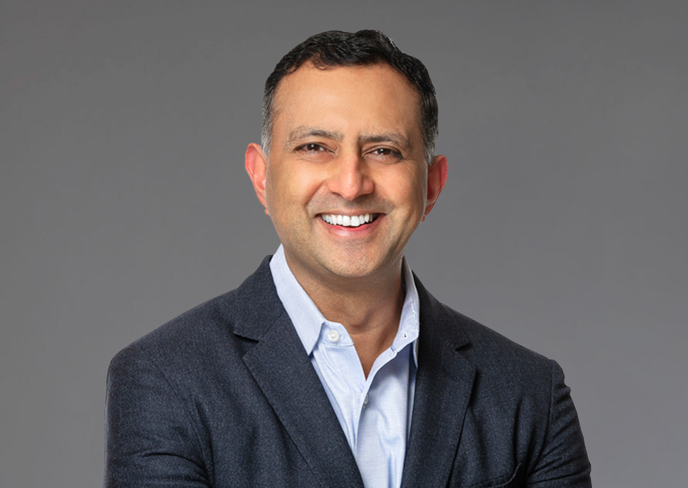 Randy Menon, new Chief Product and Marketing Officer at One Identity, smiling confidently.