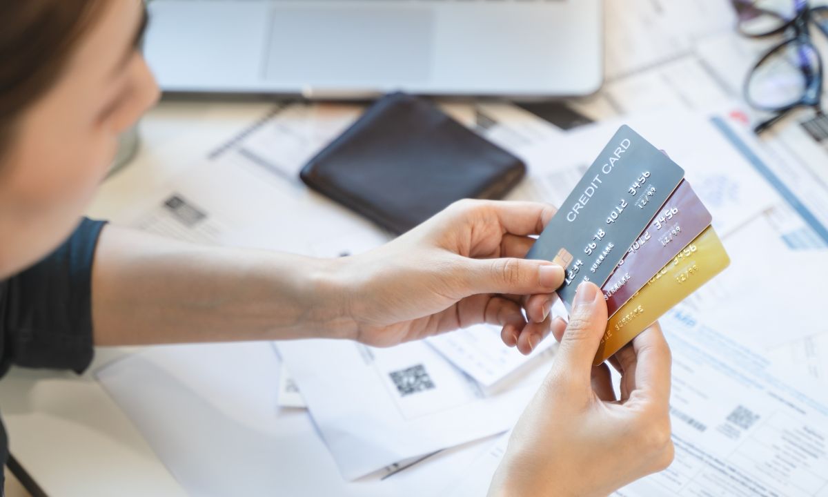 Illustration of credit cards merging with mobile payment icons and financial charts.