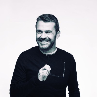 Aveni's new Chief Commercial Officer, Kent Mackenzie, standing in a modern office setting.