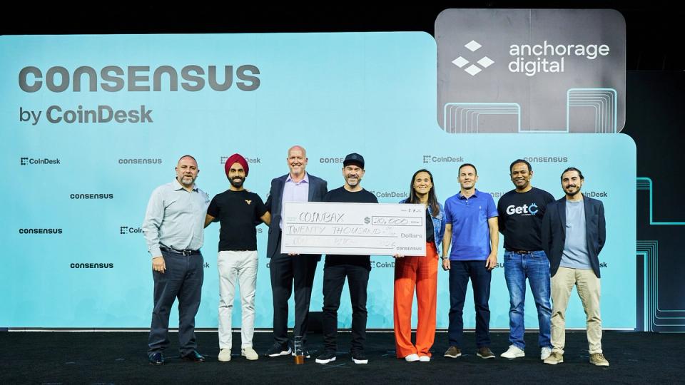 Peter Glyman of Coinbax accepts the PitchFest prize on stage at Consensus Miami.